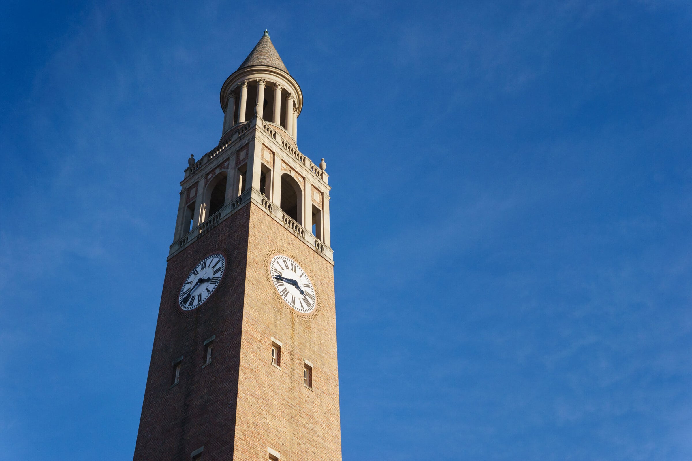 Admissions Referral Program A majestic clock tower standing tall, adorned with a prominent clock.